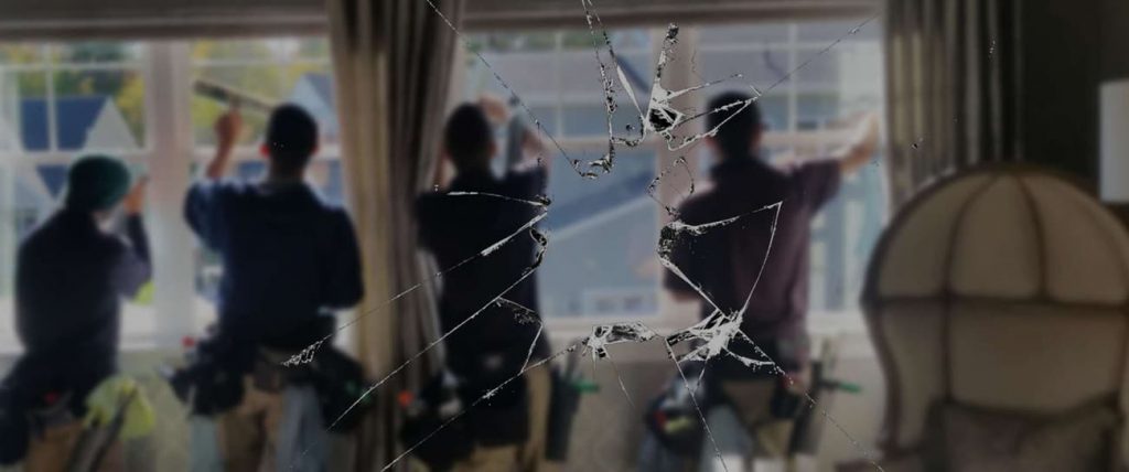 Window with broken glass pane being assessed for replacement by a glazier